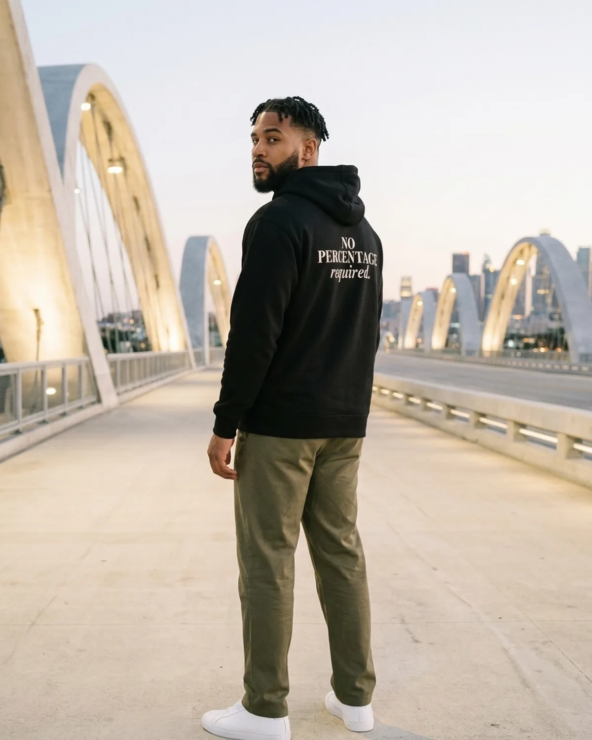 Dre looking back over his shoulder in the Black No Percentage Hoodie on the Sixth Street Viaduct