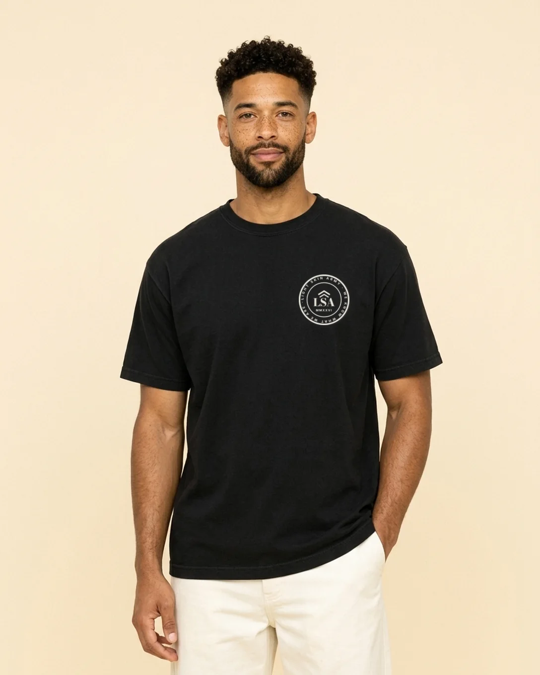 Model wearing the Unit Patch tee in Black with the Light Skin Army crest on the left chest