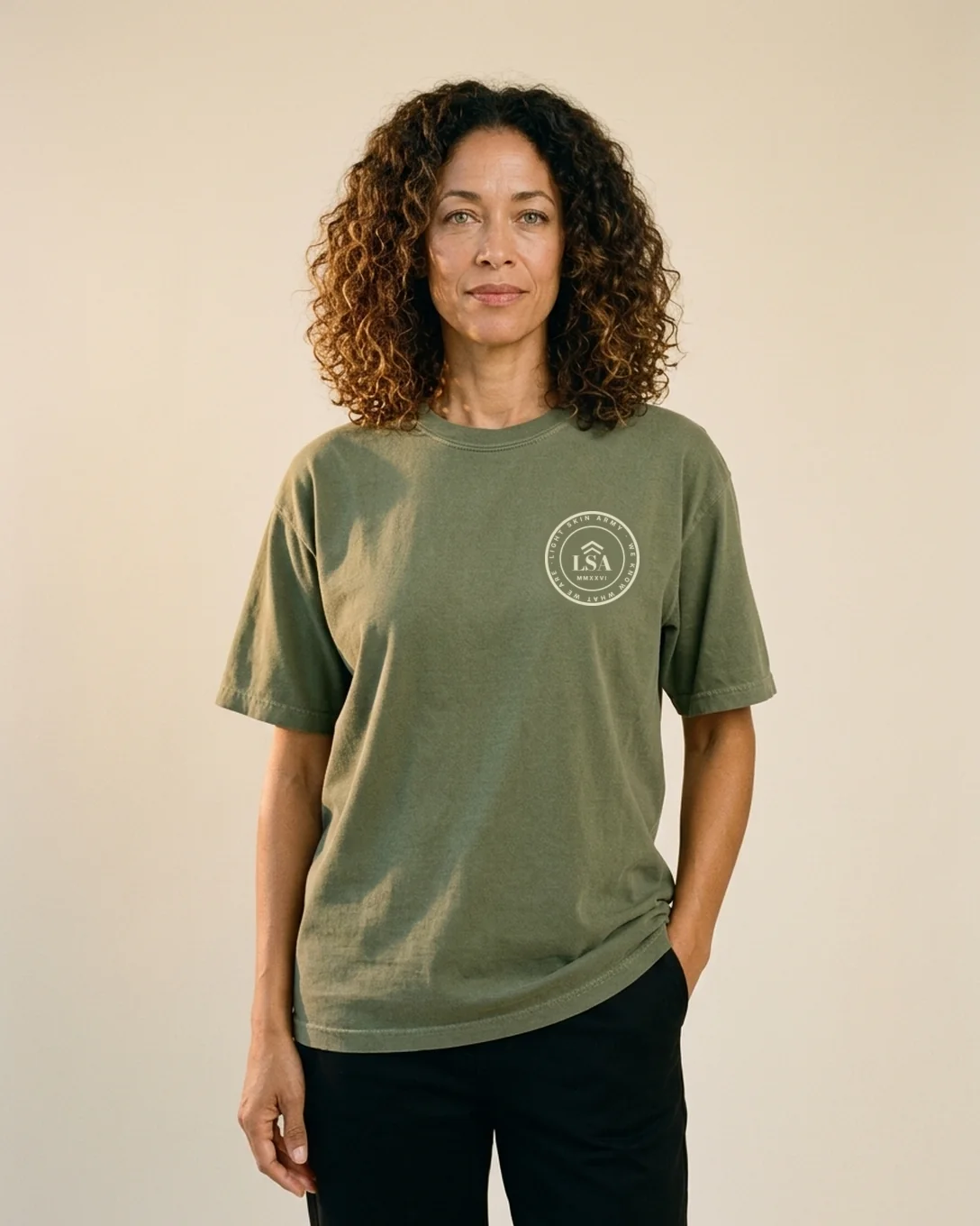 Model wearing the Unit Patch tee in Moss with the Light Skin Army crest on the left chest