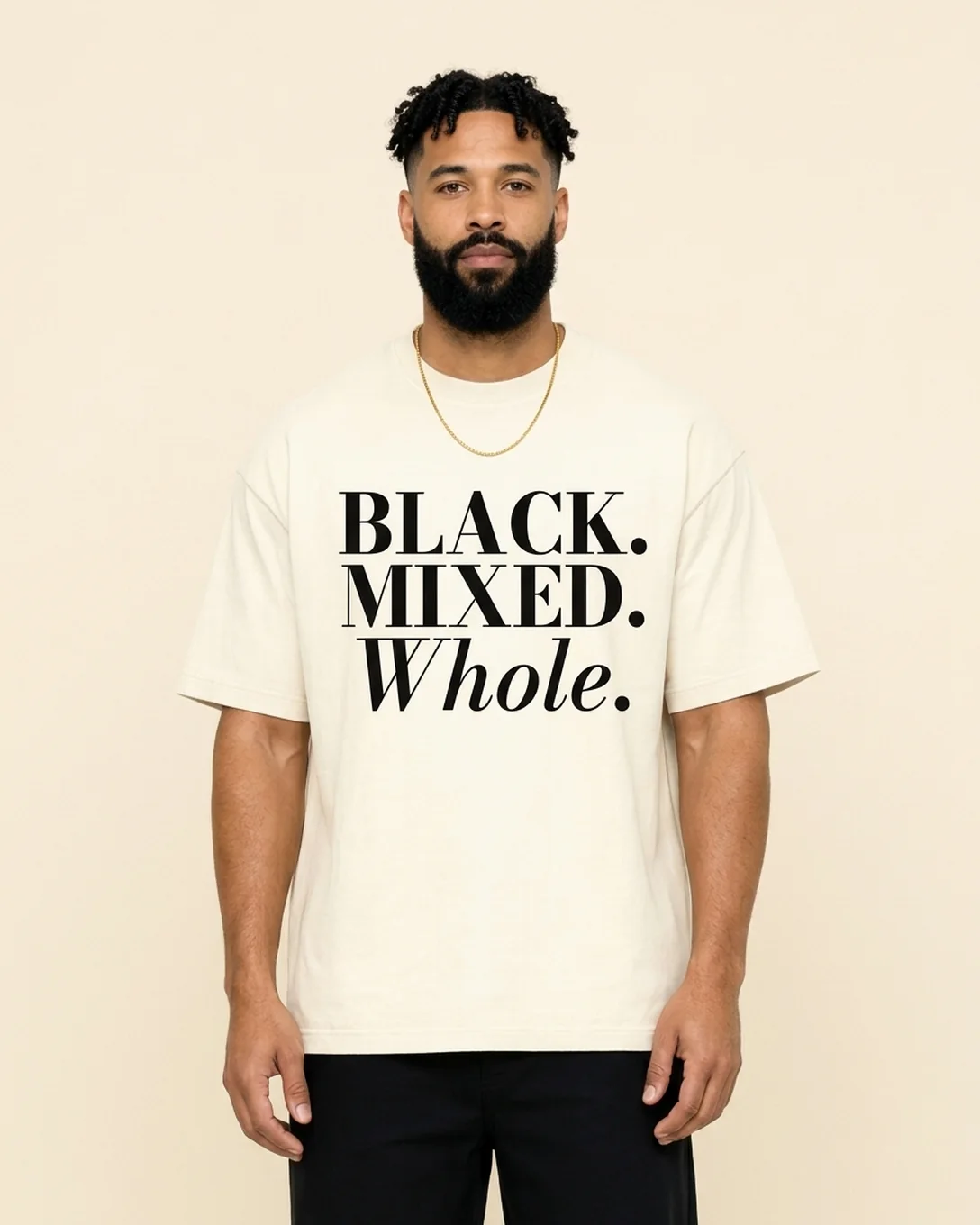 Model wearing the Whole tee in Ivory, reading BLACK. MIXED. Whole.